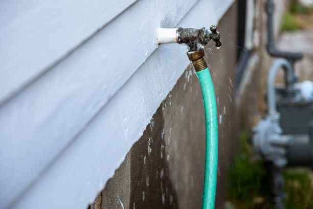 Dripping Leaky Outdoor Faucet on side of building