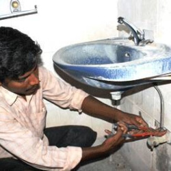 plumber working on a sink. 